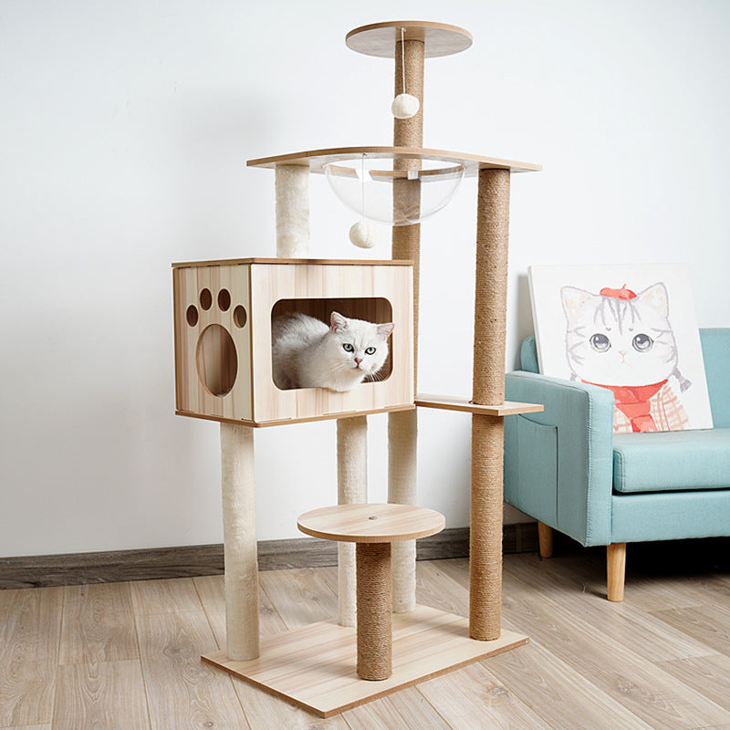 Wooden cat tree with a cat peeking out in a living room setting